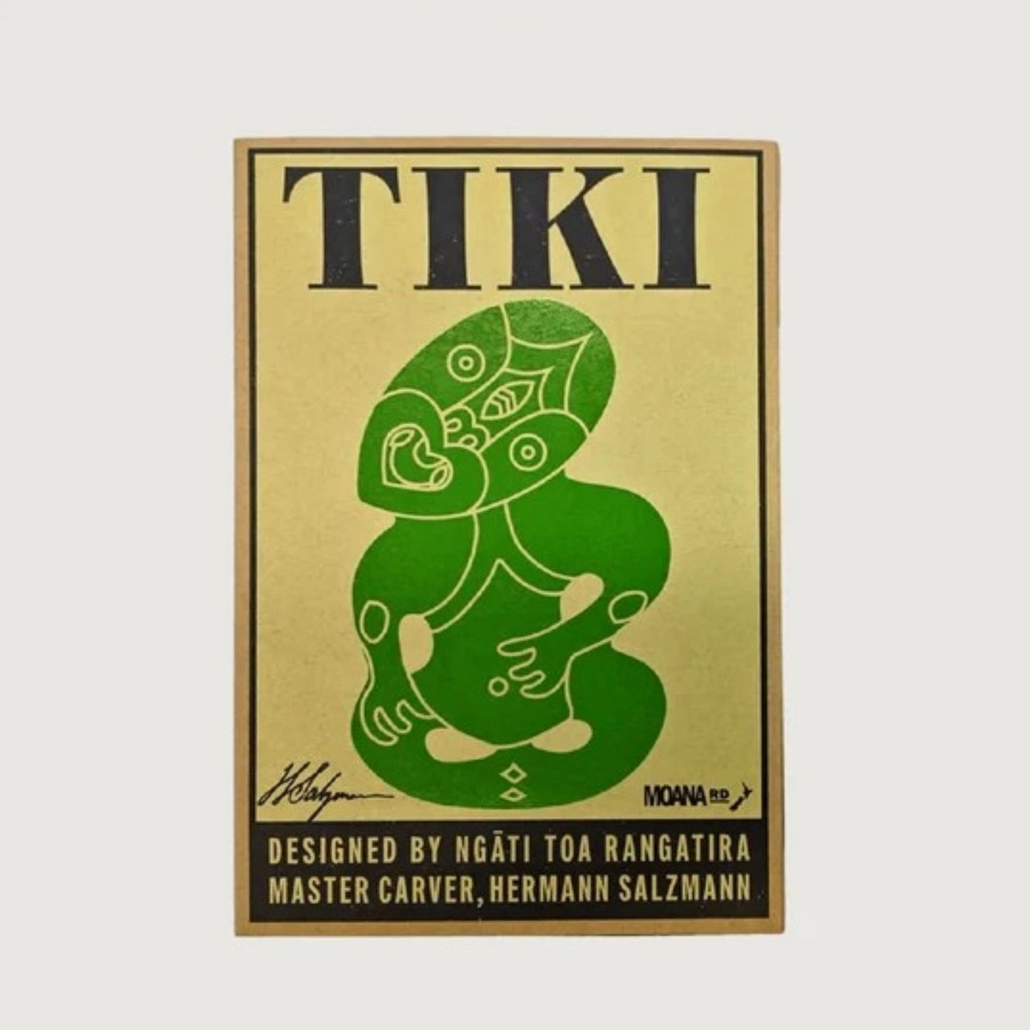 Ornament-Glass-Tiki-Green-6.5x10.5cm-Small. Gold and green tiki design with text on a white background