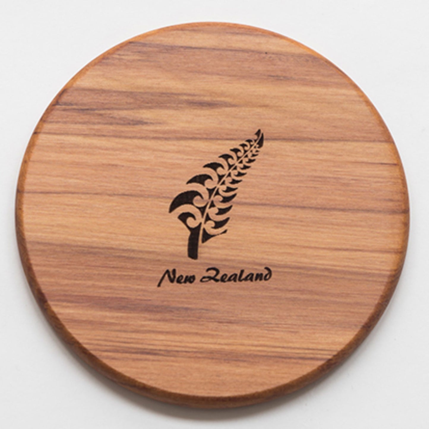 handmade silver fern Rimu coaster on a white background