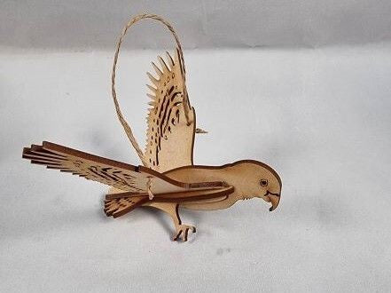 Wooden 3D Kea bird ornament with outstretched wings on a white background