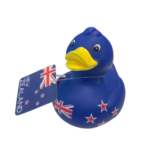 A blue rubber bath duck with New Zealand flag design and a yellow beak, with a tag that reads 'New Zealand'.