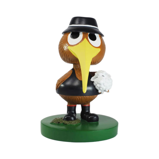 Animated character figurine with a hat and yellow beak on a white background
