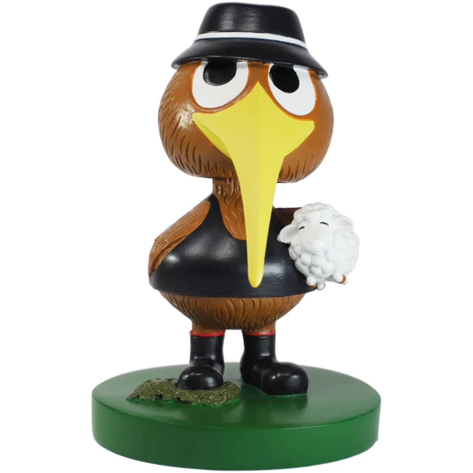 Animated kiwi farmer character figurine with a hat and a sheep on a green base. bobblehead.