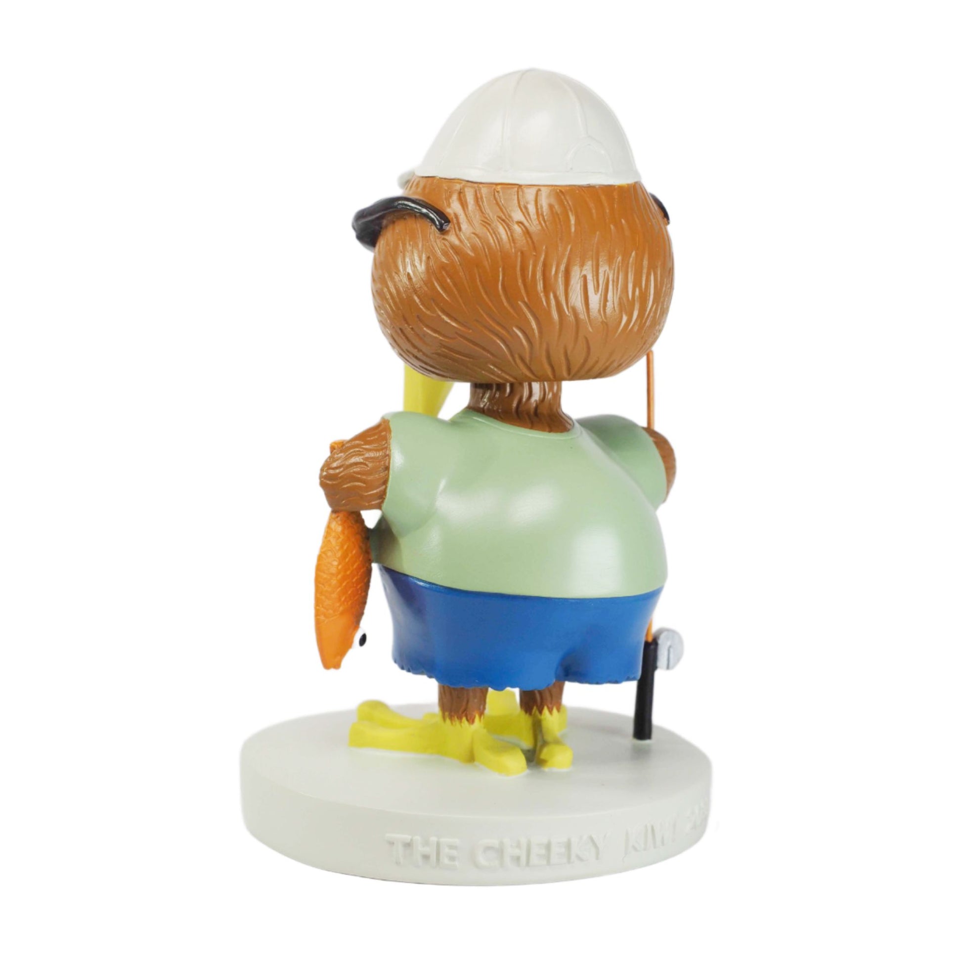 Figurine of a kiwi character with a carrot, wearing a green shirt and blue pants, on a white background.