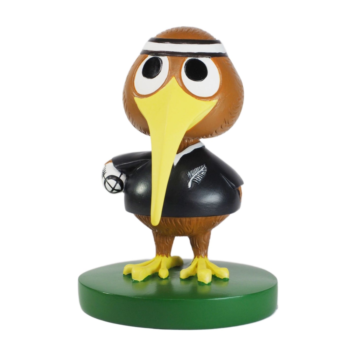 Figurine of a kiwibird character with a yellow beak and black outfit on a green base