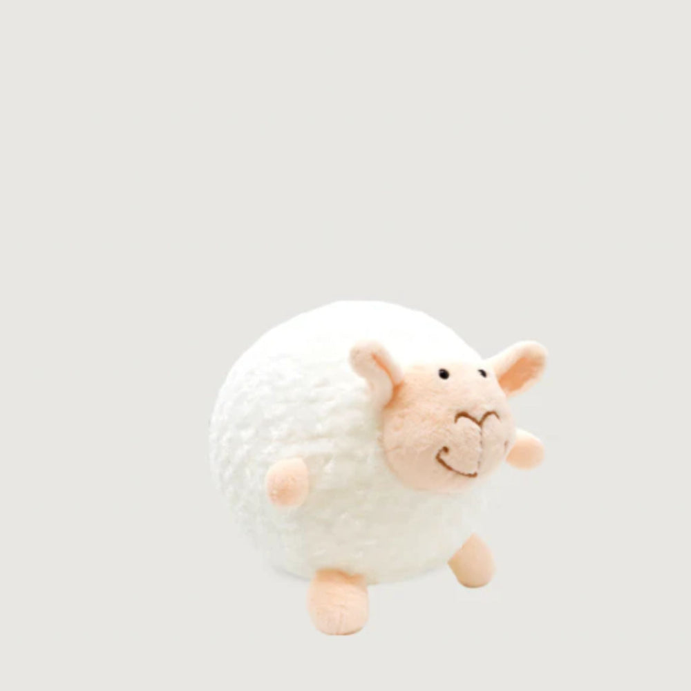 Plush toy sheep on a light gray background
