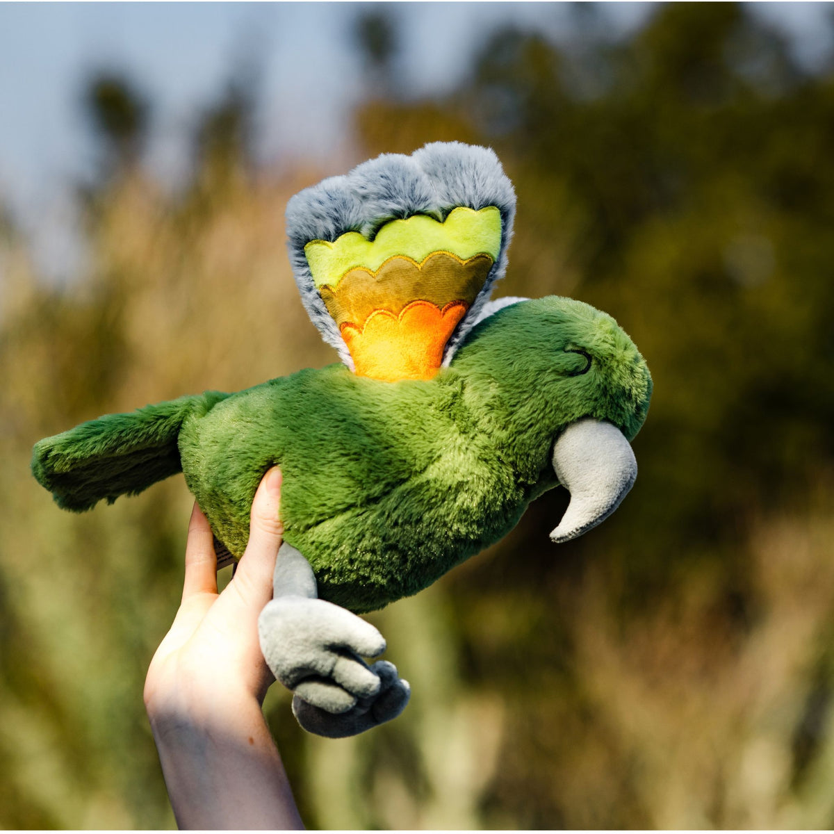 holding kea bird soft toy mudium outside