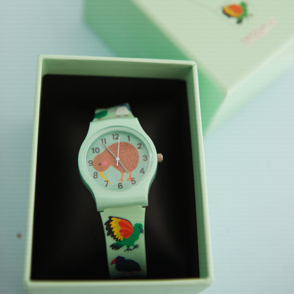 Children's kiwi watch with colorful design in a green box on a light blue background