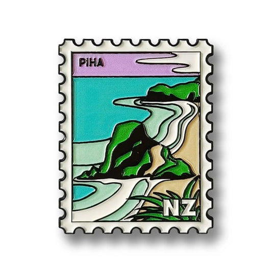 Enamel magnet with a design of a coastal landscape and 'NZ' on a white background