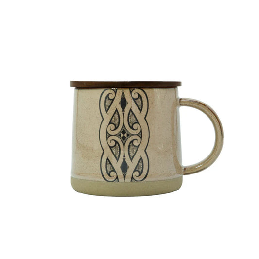 Moana Road Miriama Grace-Smith Glazed Ceramic Mug – BrownBeige mug with decorative black pattern on a white background