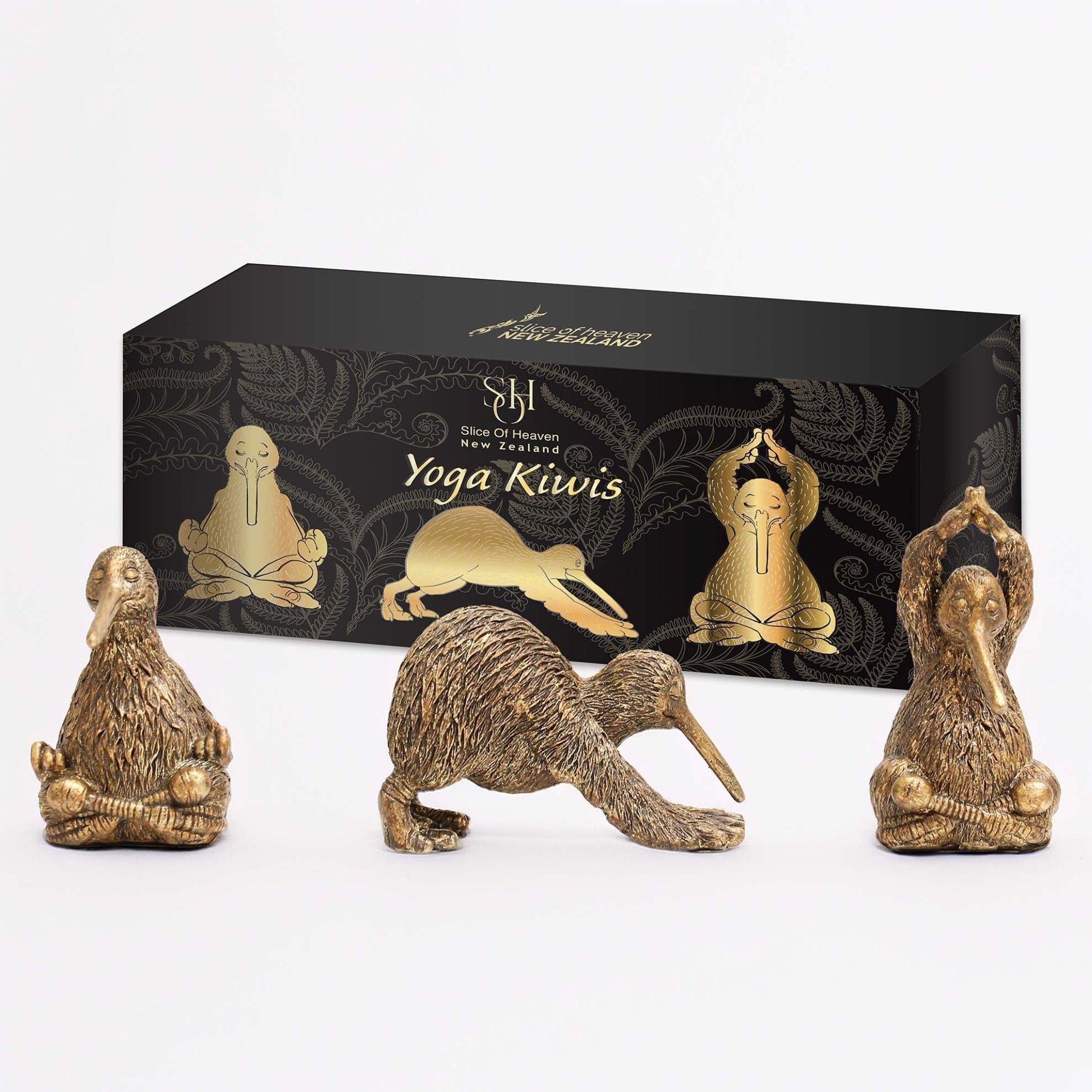 Yoga Kiwi Ornaments 3 Pack. Gold yoga kiwi figurines in front of a black box with 'Yoga Kiwis' branding.