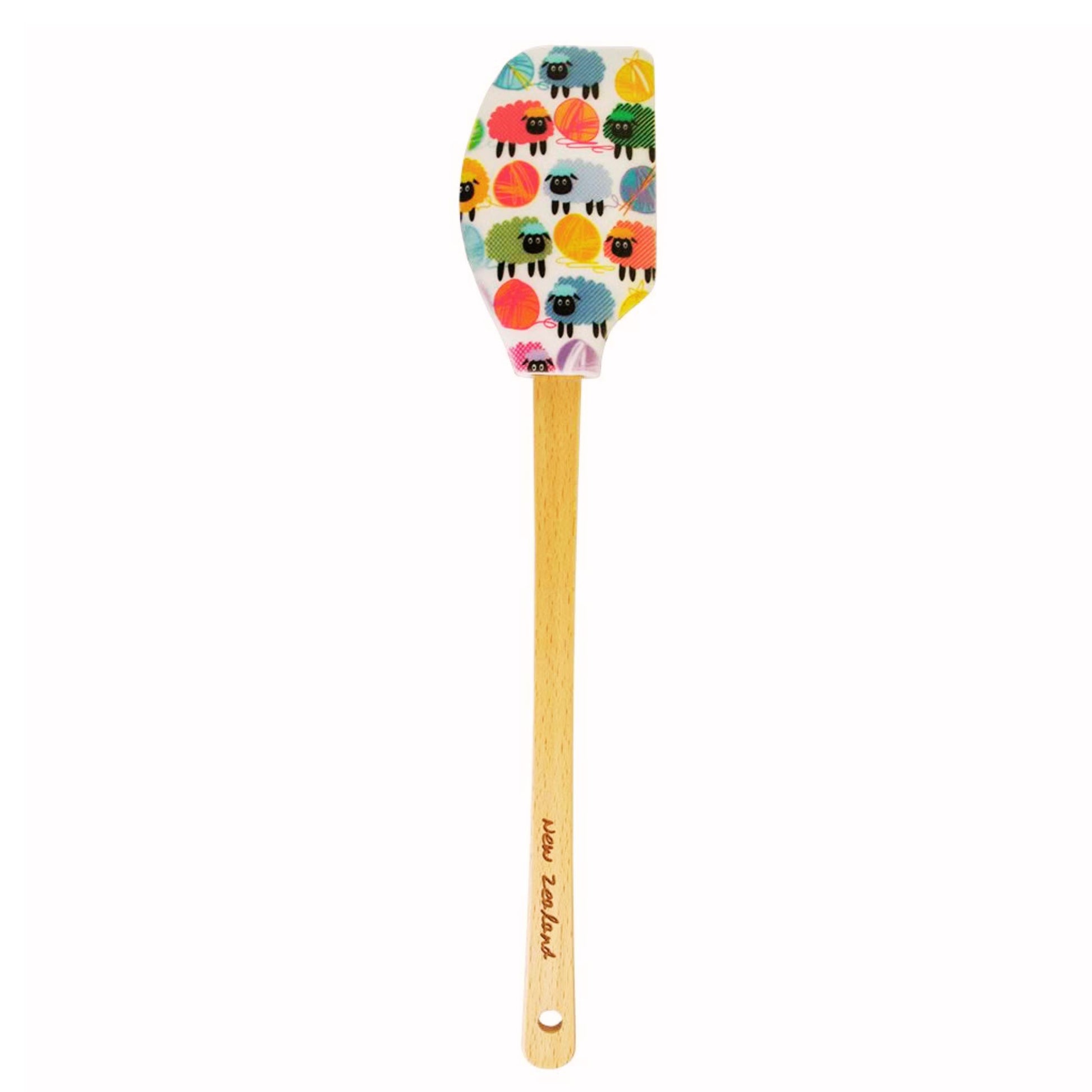 Spatula with colorful sheep pattern on a wooden handle against a white background. Spatula-Woolly-Brights
