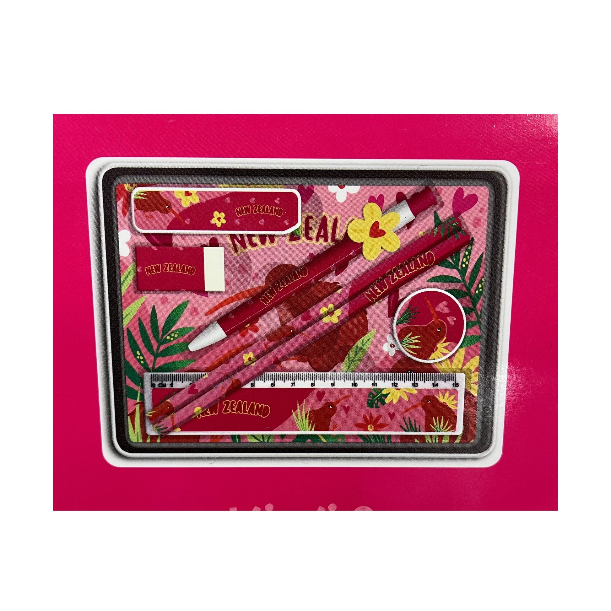 Stationery set with pens, ruler, and eraser on a pink background