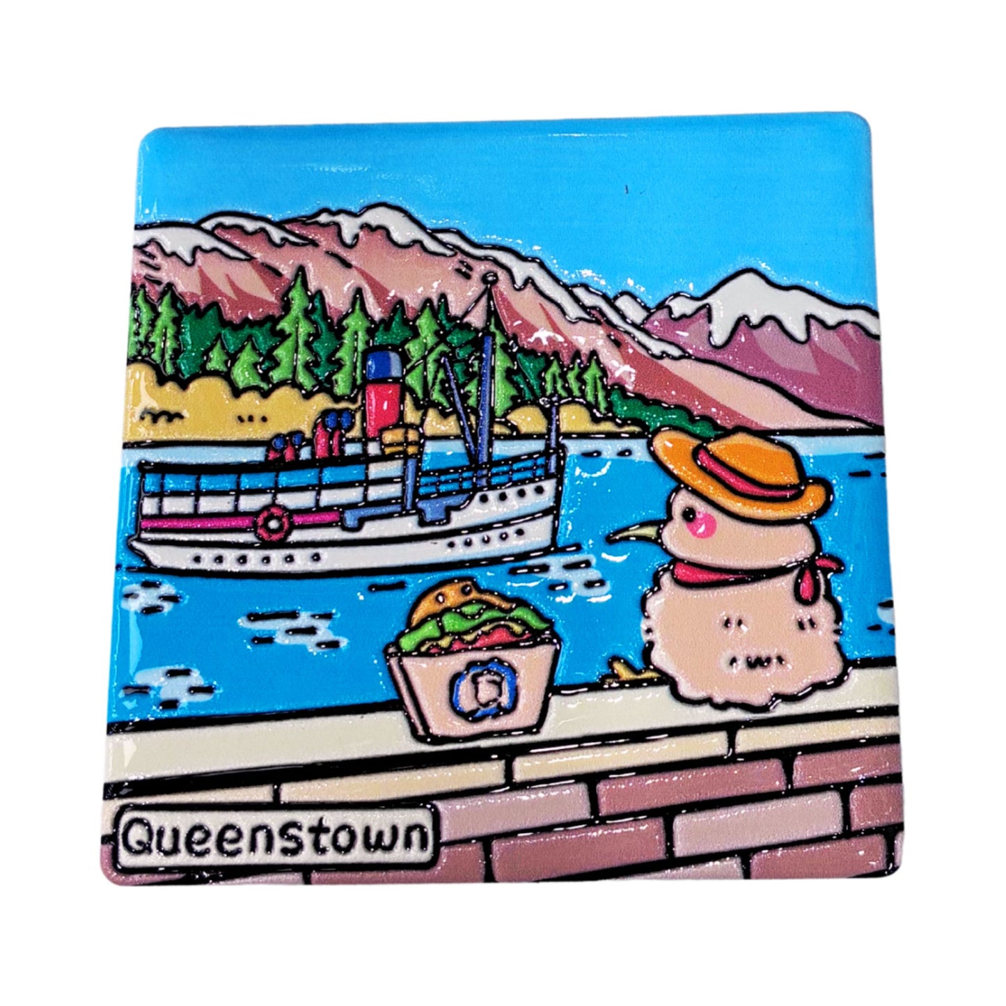 A square ceramic tile coaster featuring a colorful cartoon illustration of Queenstown, Ontario. The artwork depicts a boat on blue water with mountains and pine trees in the background, alongside a snowman wearing a yellow hat and a basket of greens.