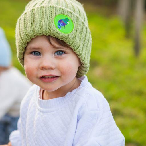 Toddler wearing green beanie