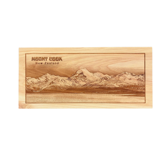 A wooden plaque with a laser-engraved image of Mount Cook, featuring a wall hanger on the back.