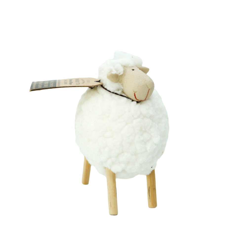 Decorative sheep figure with a white fleece and wooden legs on a white background