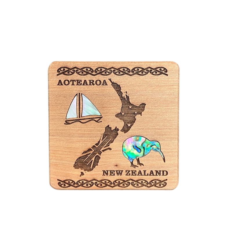 Wooden coaster with New Zealand design, including a map, sailboat, and kiwi bird.