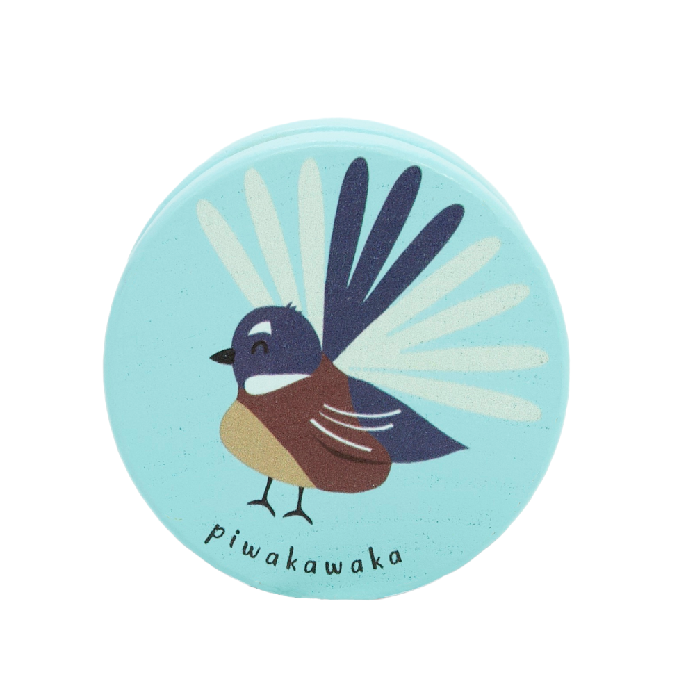 Round wooden yoyo with a bird design and 'pwakawaka' text on a light blue background