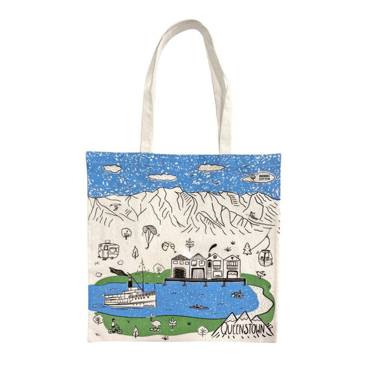 Tote bag with a scenic design of mountains, lake, and buildings in Queenstown on a white background