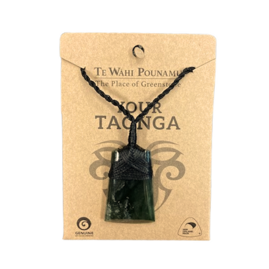 A Greenstone necklace with a pendant, packaged on a card with the text 'Your Taonga' and the place 'The Place of Greenstone'.